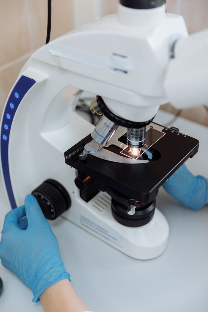 Close-up of a microscope being used for scientific research in a lab.