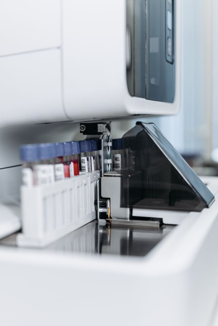 The Art of Drawing Readers In: Your attractive post title goes here Close-up of an automated laboratory machine handling test tubes for research.